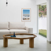 The Jamie Coffee Table enhances the living room ambiance, its glass top and wood frame complementing contemporary decor effortlessly.